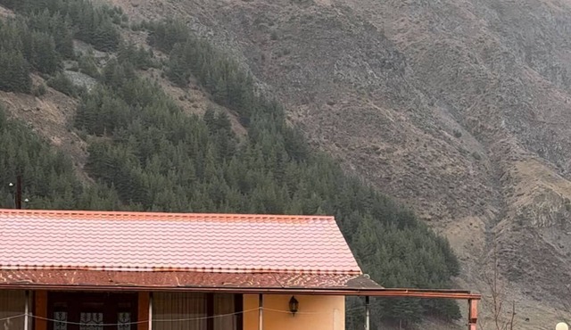 A Private Guest House in a secluded area by the river, surrounded by mountains.