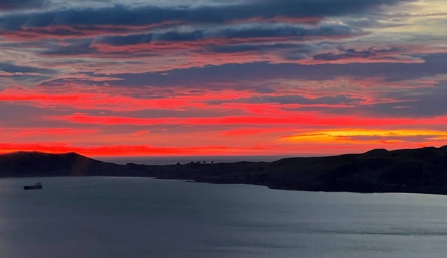 Stunning sunrises over Taiaroa Head in Dunedin
